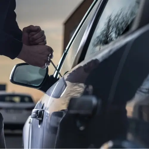 thief trying to break into car