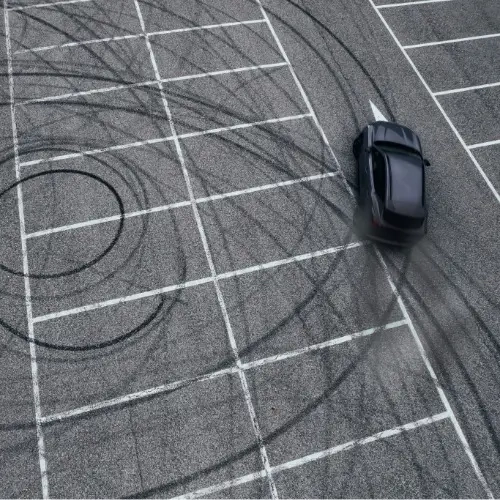 Car perfoming donuts in a parking lot