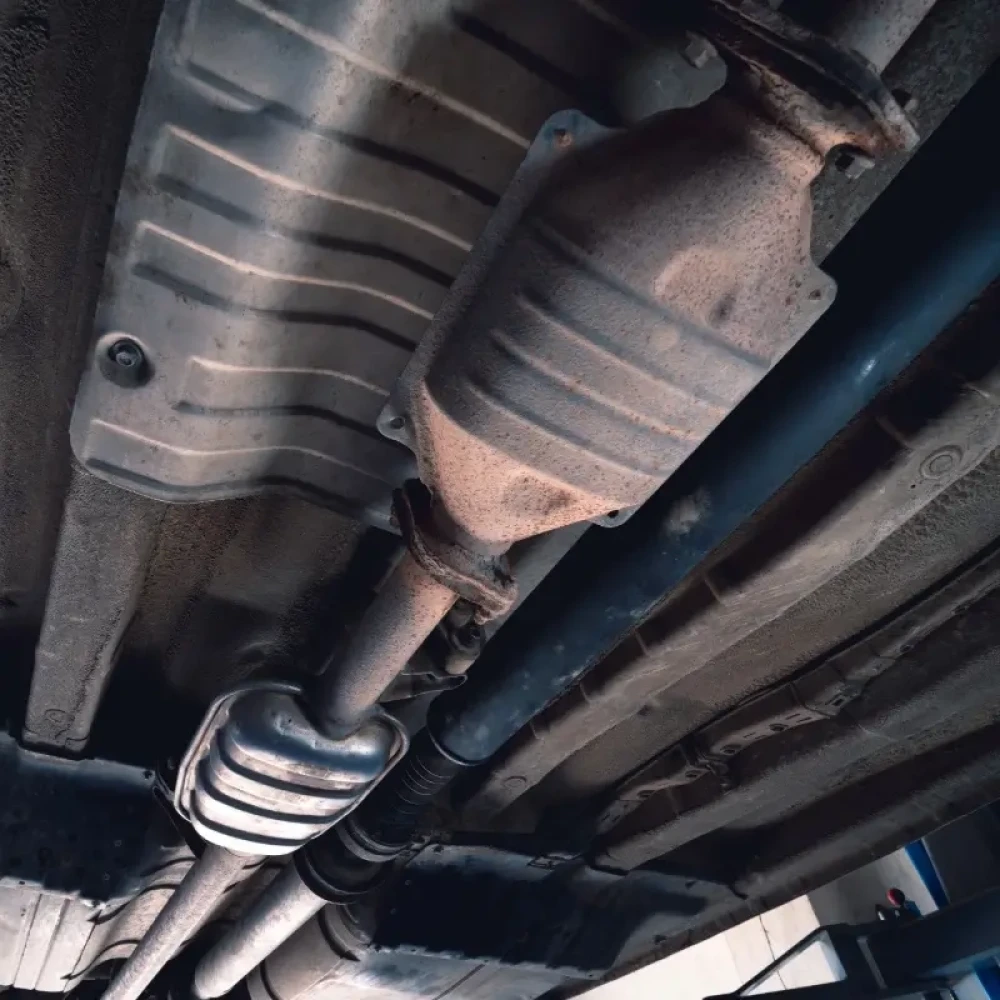 Vehicle underbody exhaust pipe, catalyst, resonator, exhaust system